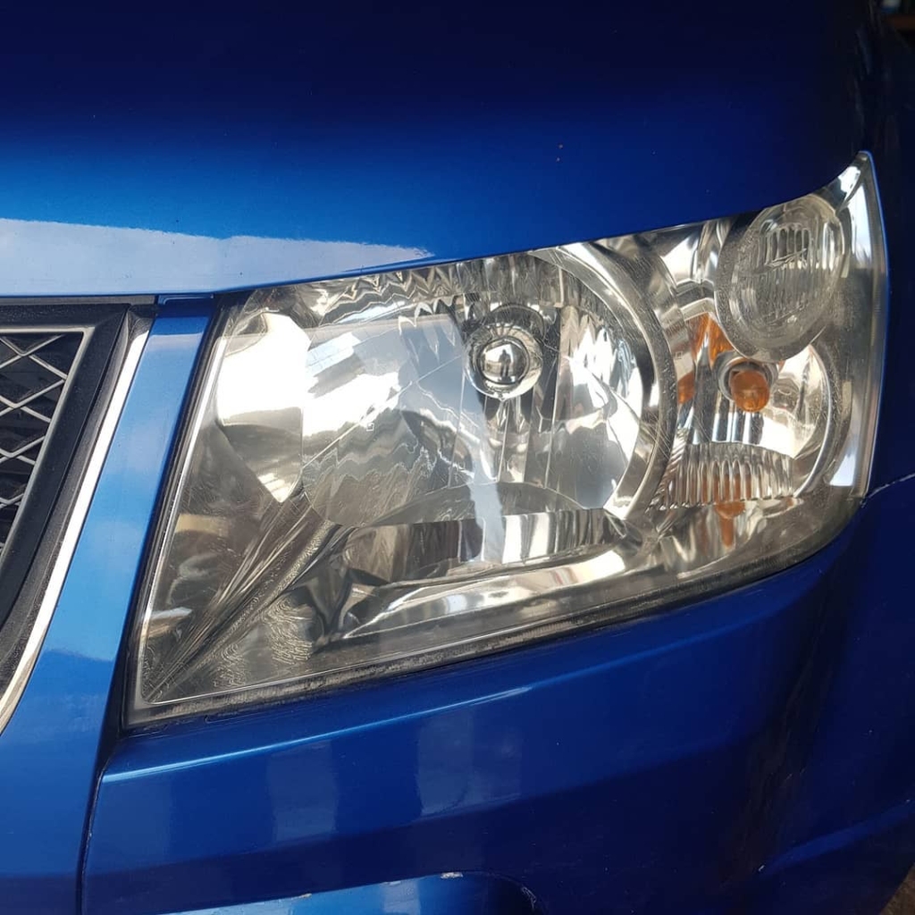 Multi-stage polishing of a plastic headlight lens to restore transparency and light output in Co. Roscommon.