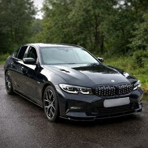 Gloss black executive sedan in Ireland, showcasing a newly installed gloss black front bumper lip splitter, side skirts and matching kidney grilles.