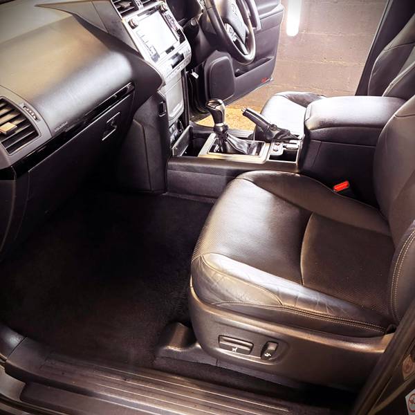 Valeted vehicle interior showing pristine floor mats and detailed dashboard trim for drivers in Foynes and Adare.
