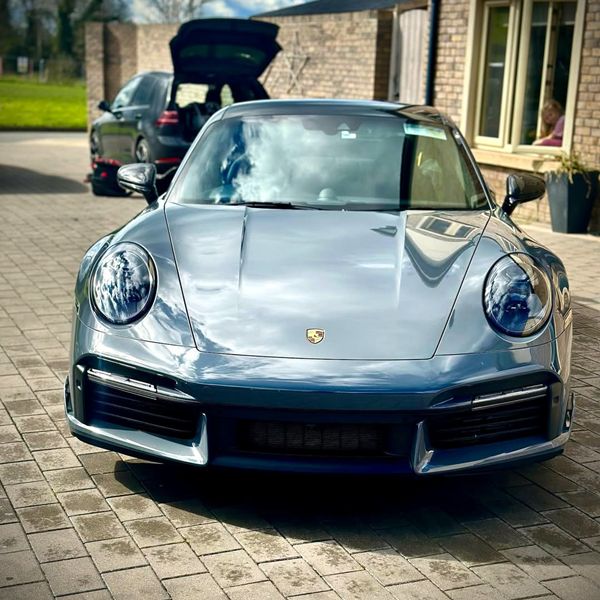 Frontal exterior view of a cobalt coloured Porsche displaying enhanced paint depth and gloss after 5-year ceramic protection.