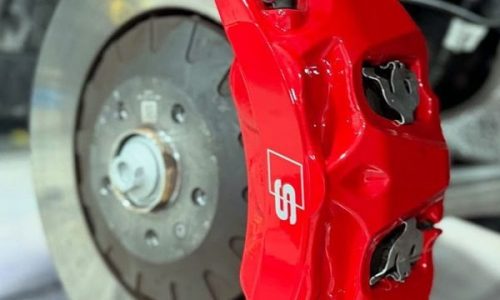 A close-up view of the complete caliper transformation: clean lines, custom color, sharp branding and a glossy, protective ceramic finish on a Robertstown and Allenwood sport car.
