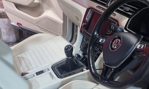 Precision application of a wear-resistant leather ceramic sealant onto a steering wheel and center console trim to shield against skin oils, sweat and friction at Car Valet Hero Athlone, Quality Car Wash & Valet.