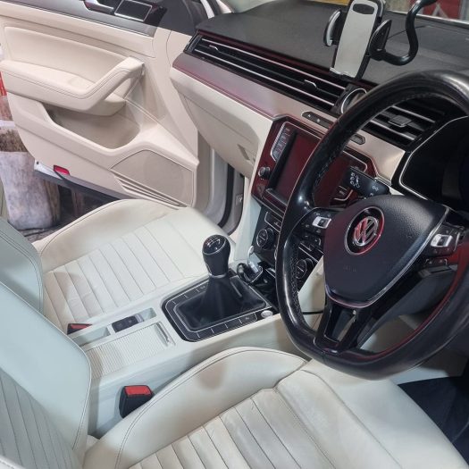 Precision application of a wear-resistant leather ceramic sealant onto a steering wheel and center console trim to shield against skin oils, sweat and friction at Car Valet Hero Athlone, Quality Car Wash & Valet.