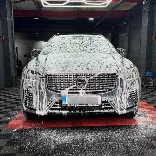 Professional hand-cleaning of a vehicle in Dublin to remove city grime.