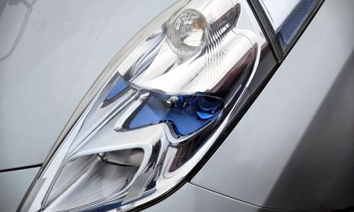 Machine polishing a hazy headlight lens with a compound pad to bring back optical clarity and a smooth finish after the sanding stages as part of Headlight restoration at Car Valet Hero Athlone, Quality Car Wash & Valet