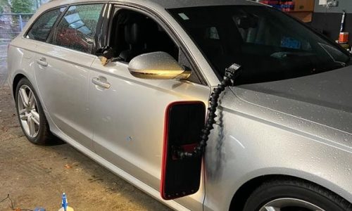 Precision dent removal on a side panel, restoring the factory lines without paint using specialised PDR lamps to identify and massage out minor surface imperfections. Specialist dent repair for high-end vehicles, serving North and South Dublin.