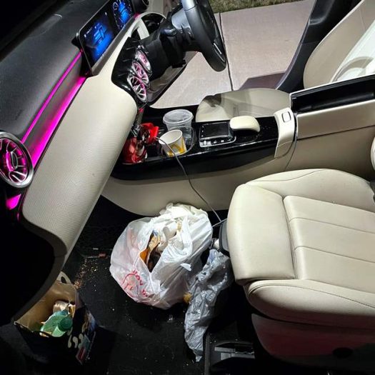 A filthy driver's footwell caked in thick, dried brown mud and grass debris, covering both the carpet floor mats and the rubber pedals. We clean all sizes of Europcar, Enterprise, Budget Car, Hertz, Avis, Car Hire, Go Car rental cars at Car Valet Hero Athlone, Quality Car Wash & Valet.